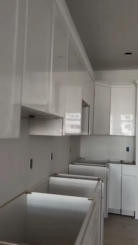 White base and wall cabinets standing in a room part-way through the install