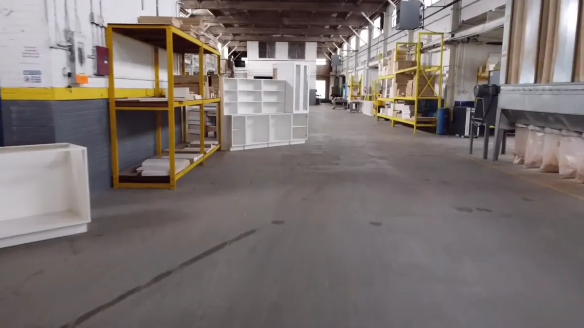 A wide aisle through the warehouse with racked panel stock either side