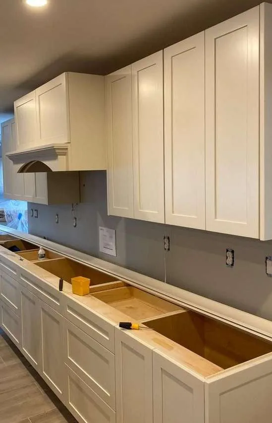 Everything on one wall — the layout an open-plan room or a rental conversion usually wants, and the shortest run that still takes four full-size appliances.