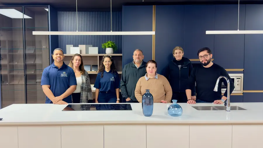 The Quality Design Cabinet team at the showroom island in Cranston